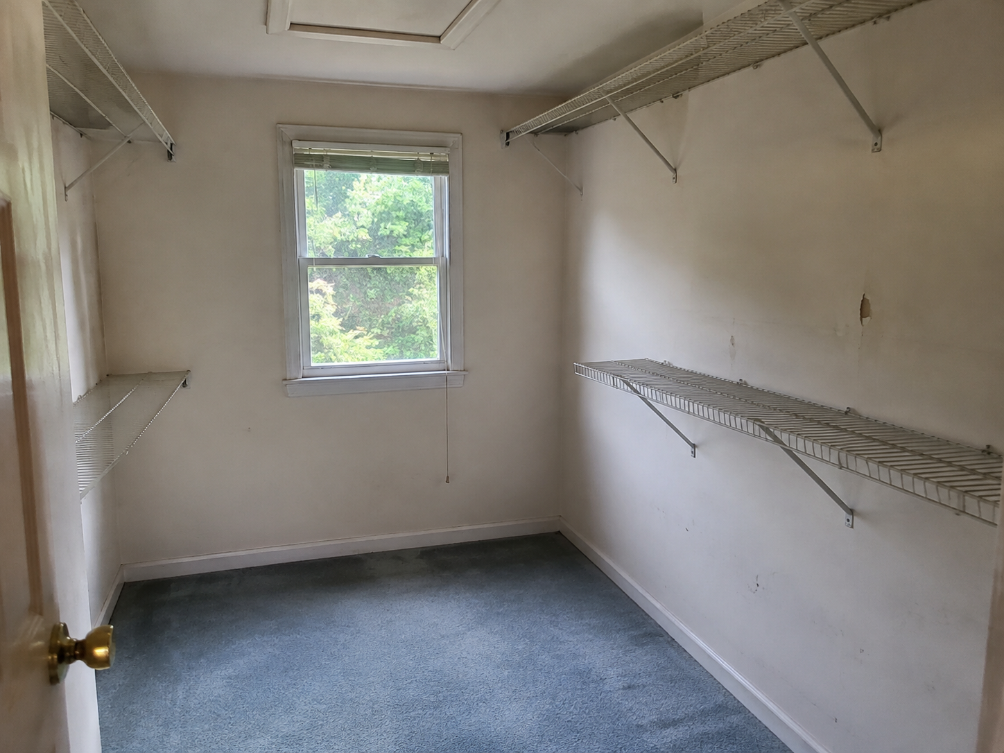 Illustrative before image showing a dated closet with wire shelving before custom carpentry