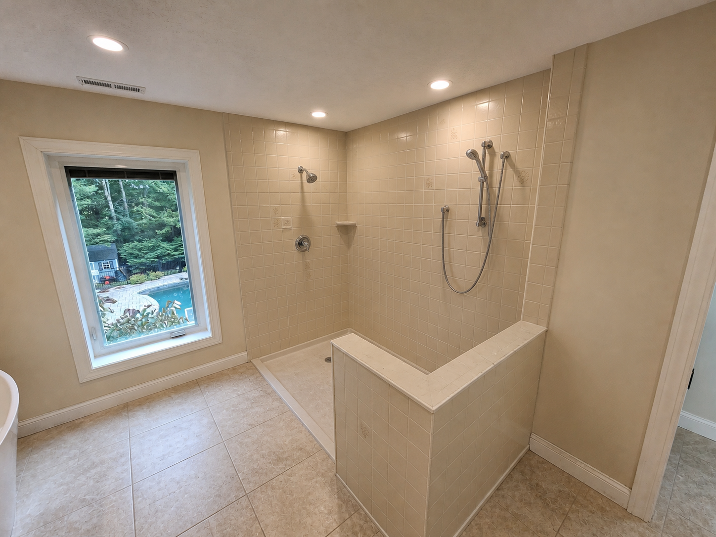 Illustrative before image showing an outdated bathroom shower before remodeling