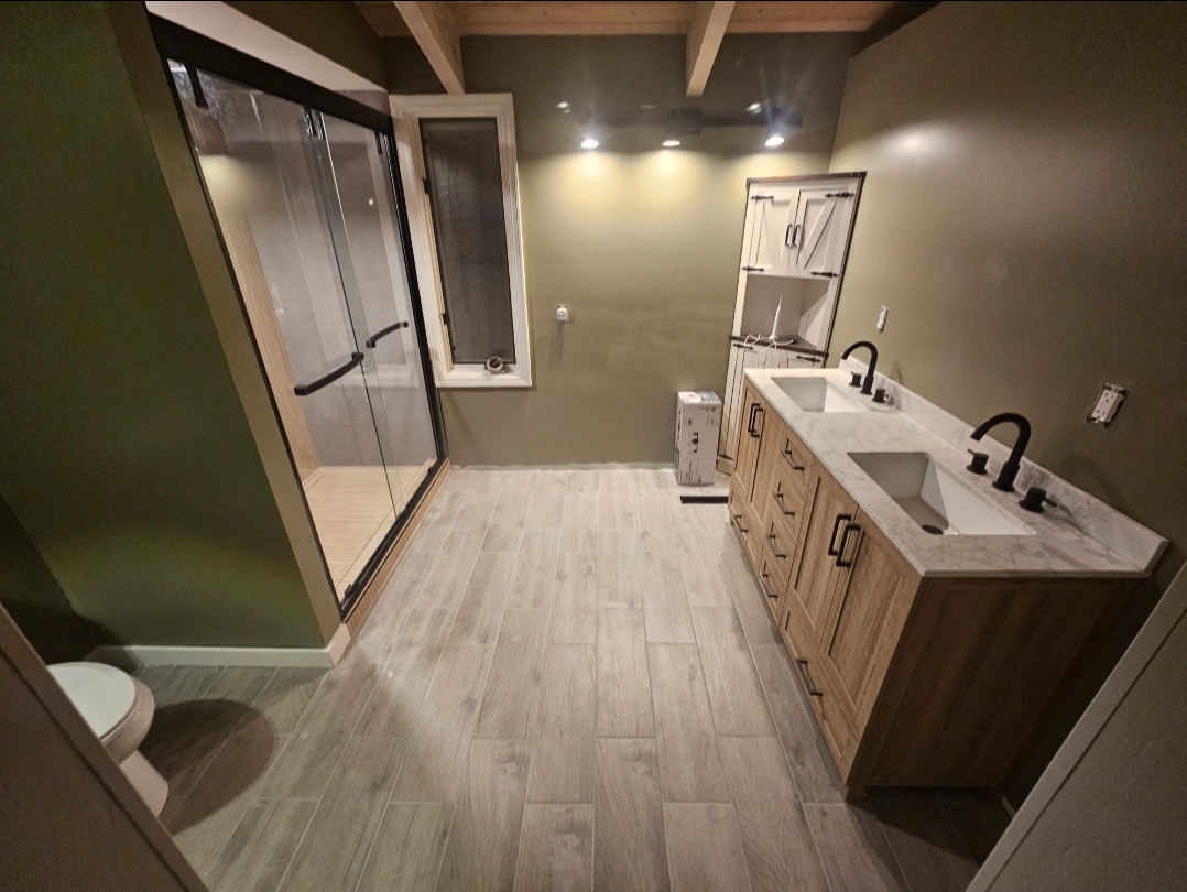 Finished bathroom with double vanity and walk-in shower