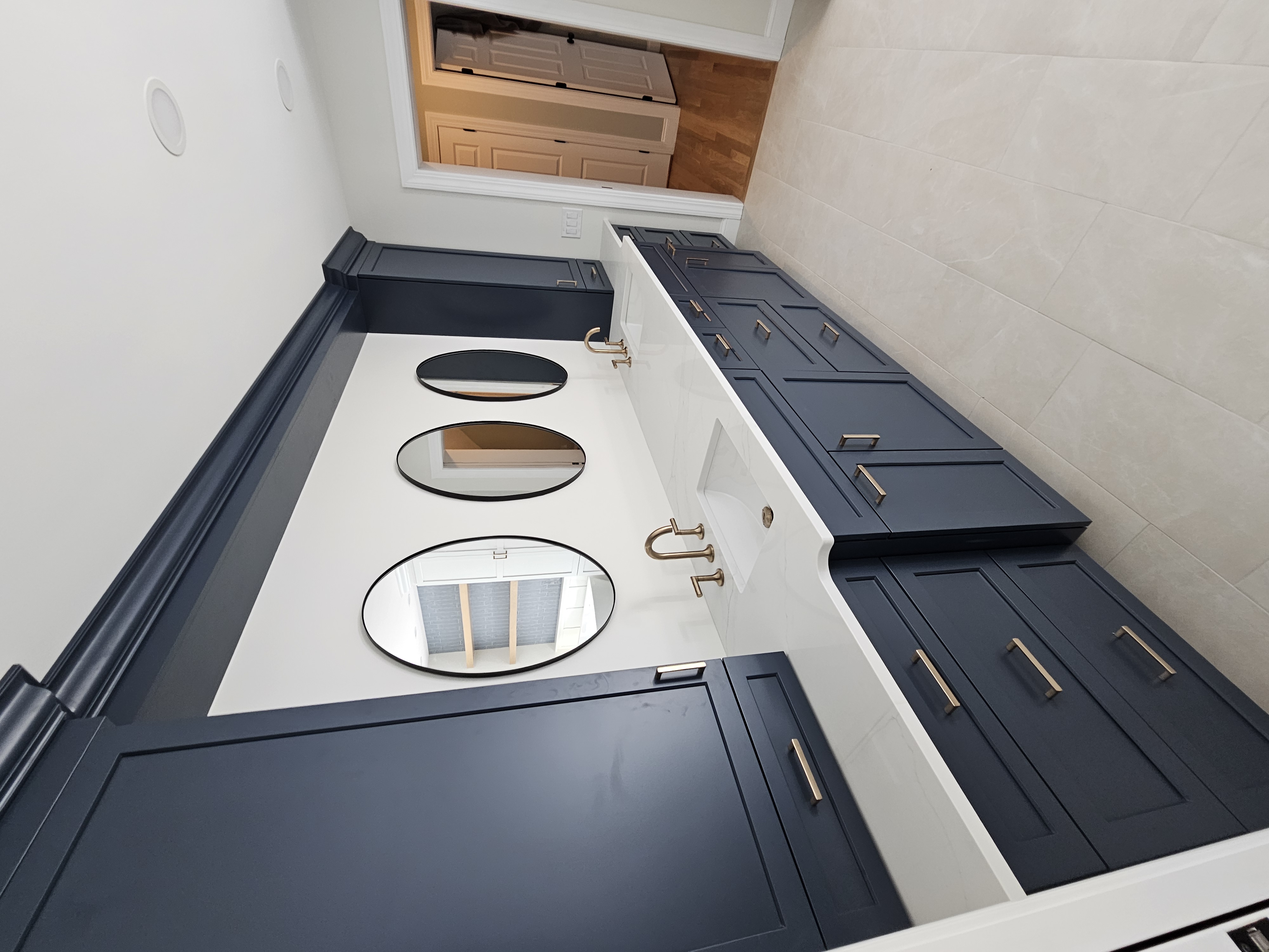 Bathroom vanity, tile floor, and finish details by K&A Remodeling